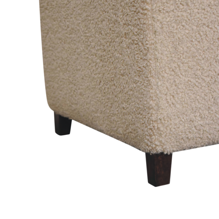 Close view of the turned legs on the Oakhurst Bouclé Ottoman in Cream.