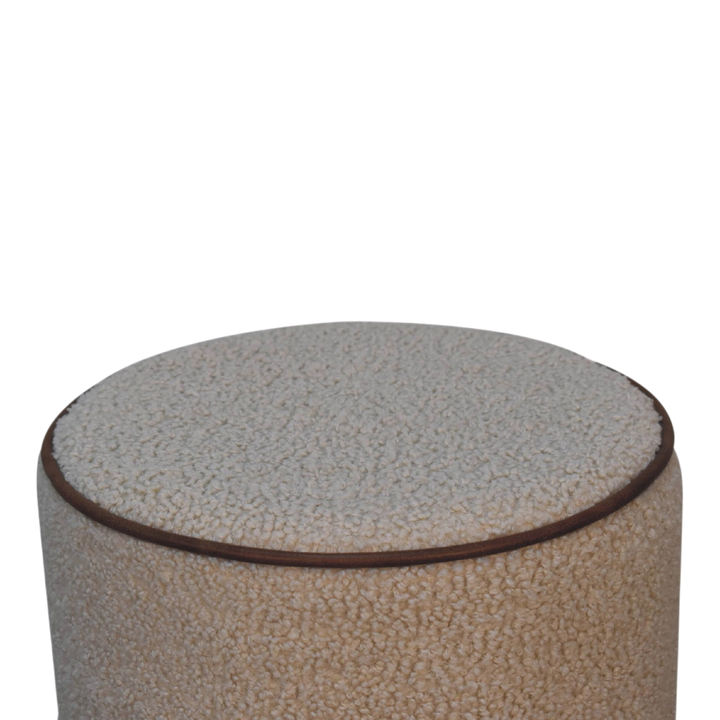 Close view of the seat on the Oakhurst Round Footstool in Cream Bouclé with Tobacco Piping.