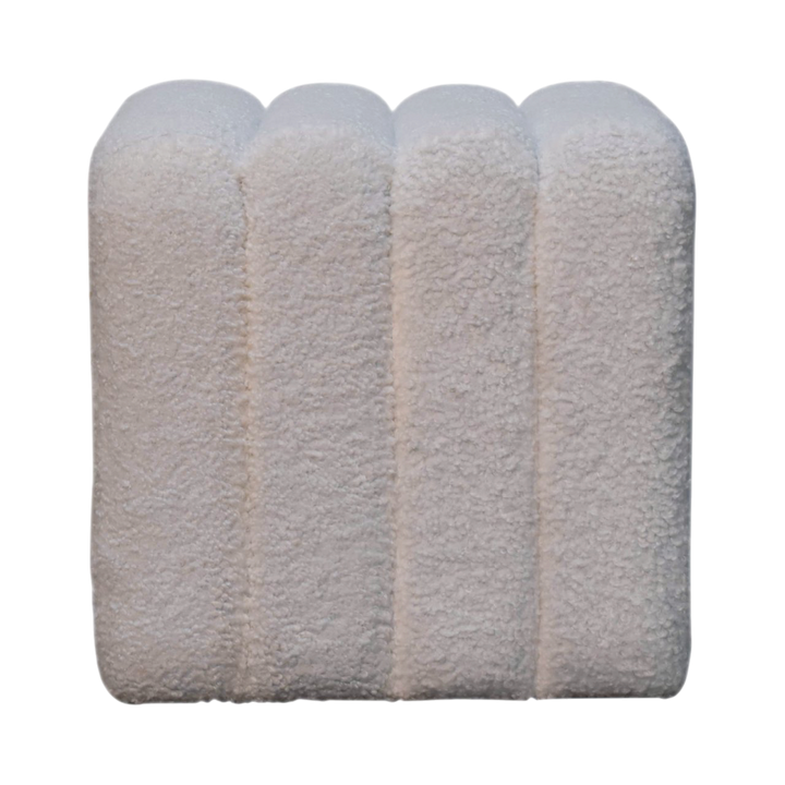 Oakhurst Wave Footstool in Alabaster Bouclé, front view. Alabaster bouclé in cotton and natural yarn over a solid hardwood frame, waved top, fully upholstered.