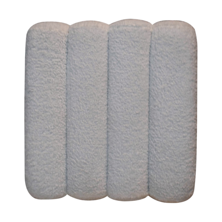 Close view of the buttoning on the Oakhurst Wave Footstool in Alabaster Bouclé.