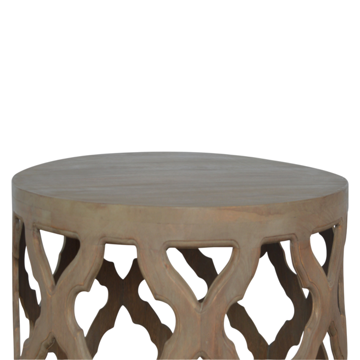 Palladio Carved Stool in Stone, three-quarter view showing the full profile.