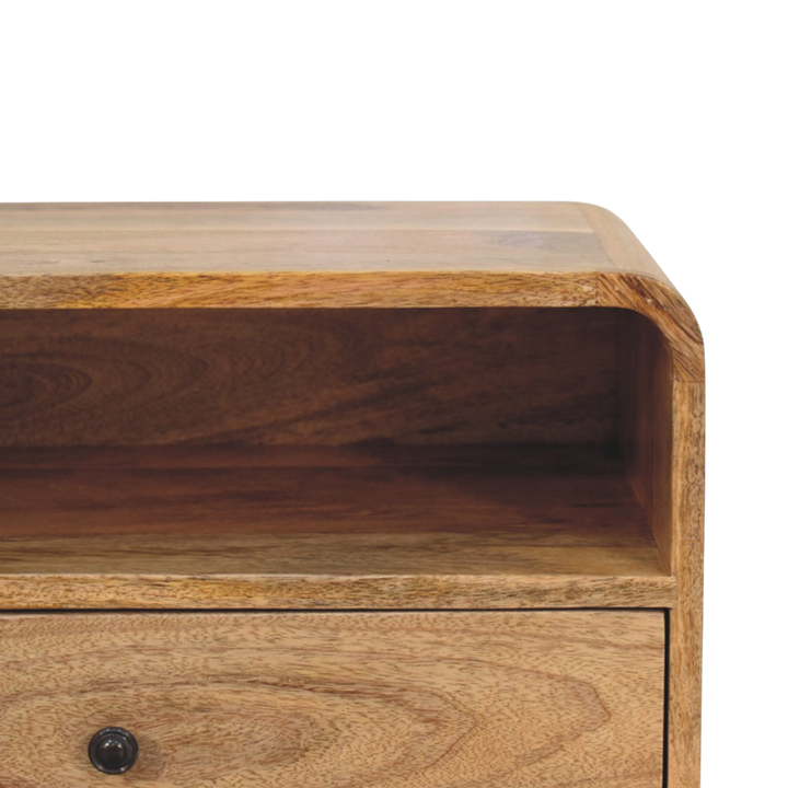 Close view of the shelf on the Pimlico Curved Wall-Mounted Bedside Table in Amber.