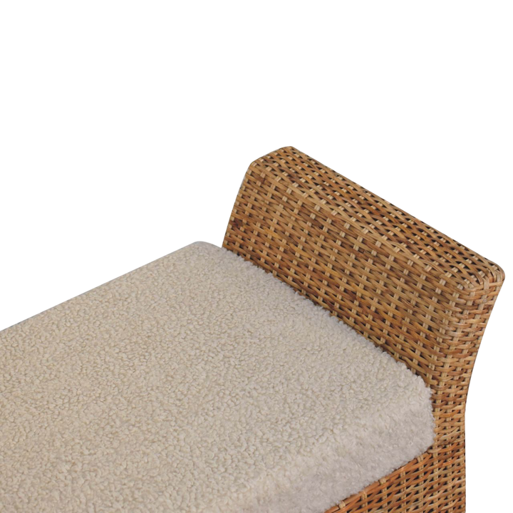 Close view of the upholstered seat on the Serafina Scroll-Arm Bench in Rattan and Cream Bouclé.