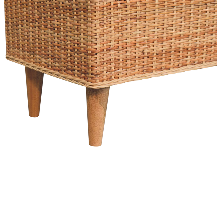 Close view of the turned legs on the Serafina Scroll-Arm Bench in Rattan and Cream Bouclé.