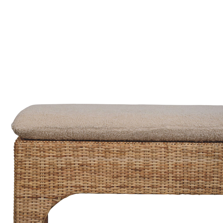 Serafina Woven Bench in Natural Rattan and Cream Bouclé, three-quarter view showing the full profile.