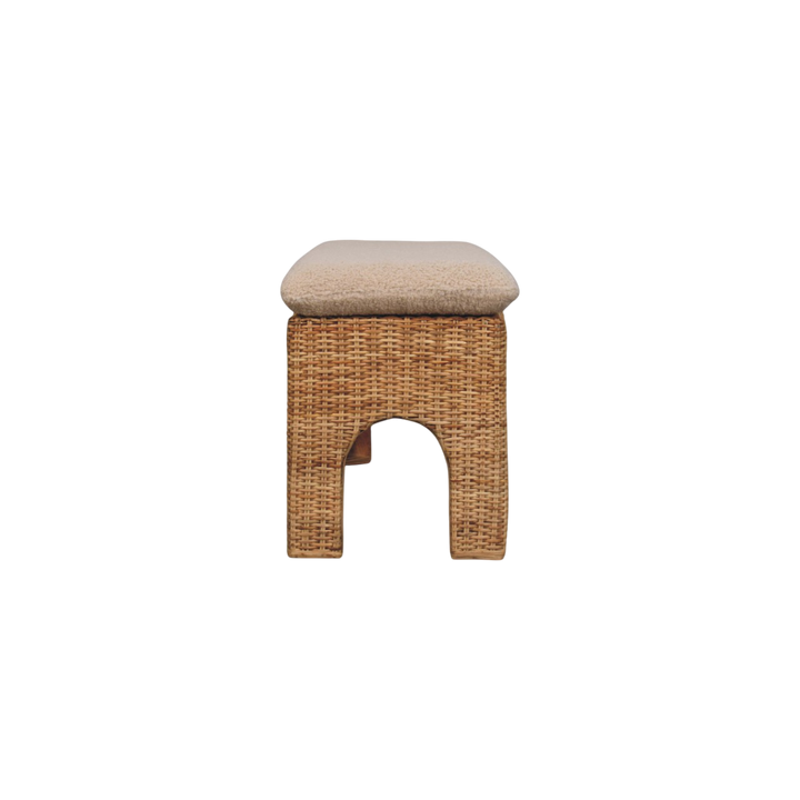 Serafina Woven Bench in Natural Rattan and Cream Bouclé, viewed from the end.