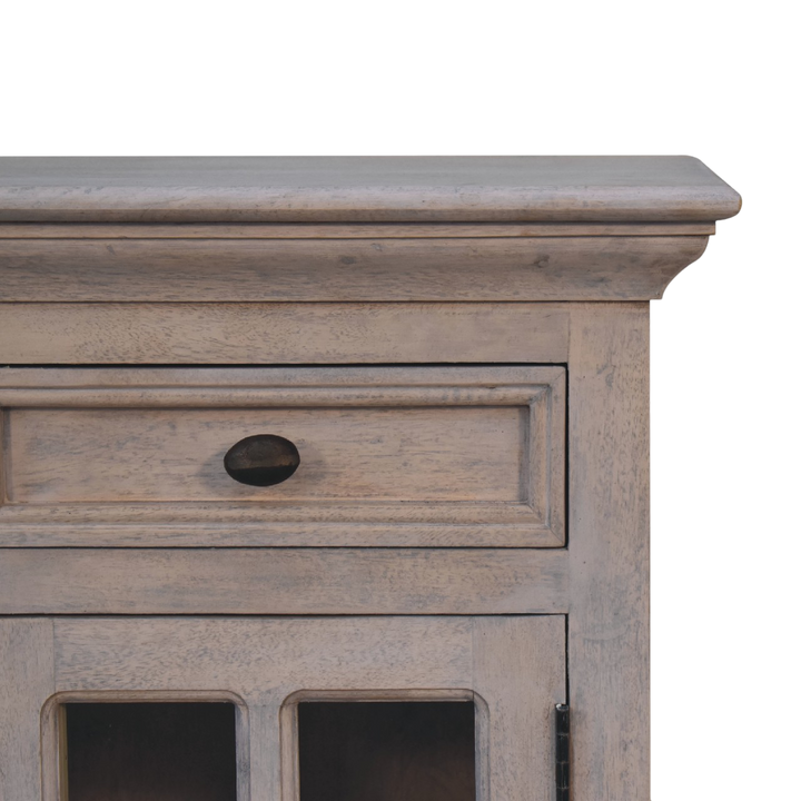 Close view of the glazed door and brass knob on the Sigtuna Glazed Bedside Table in Stone.