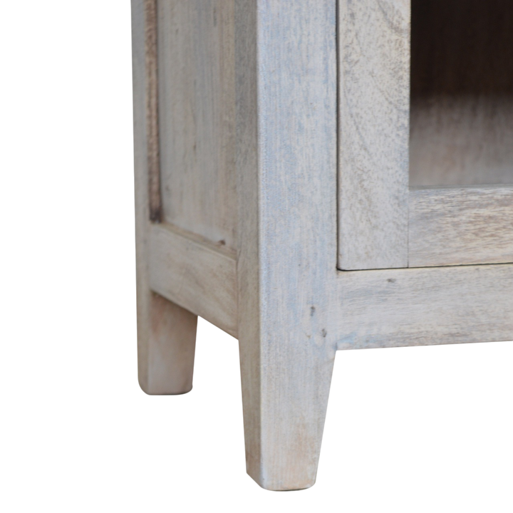 Close view of the glazed door and brass knob on the Sigtuna Mini Glazed Bedside Table in Stone.
