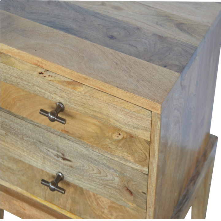 Close view of the brass hardware on the Skagen 2-Drawer Bedside Table in Amber.