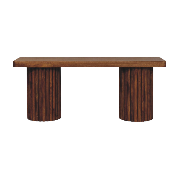 Skagen Fluted Bench in Amber, front view. Solid hardwood throughout in an amber finish, rectangular top carried on two fluted cylindrical bases.