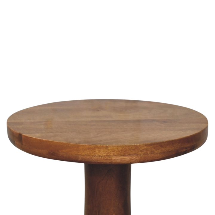 Close view of the top on the Soller Pedestal Drink Table in Amber.