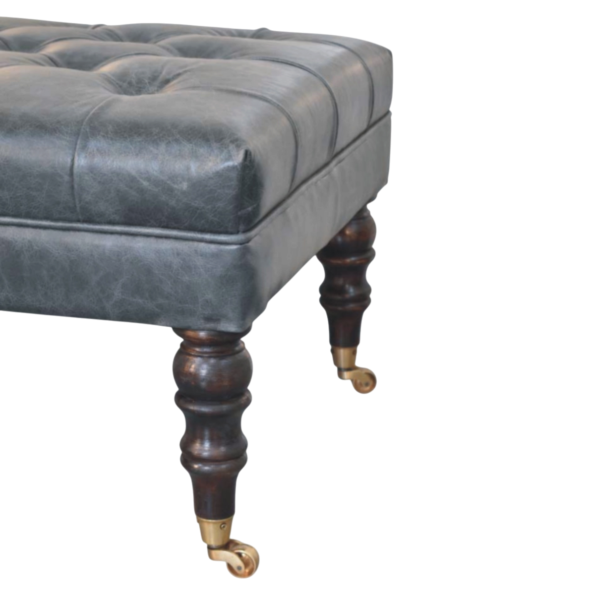Close view of the brass castors on the Sussex Leather Bench Ottoman in Slate.