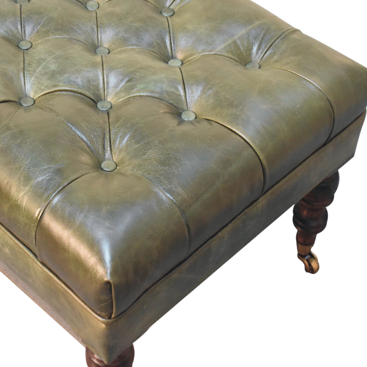 Close view of the button tufting and upholstery on the Sussex Leather Ottoman in Antique Green.