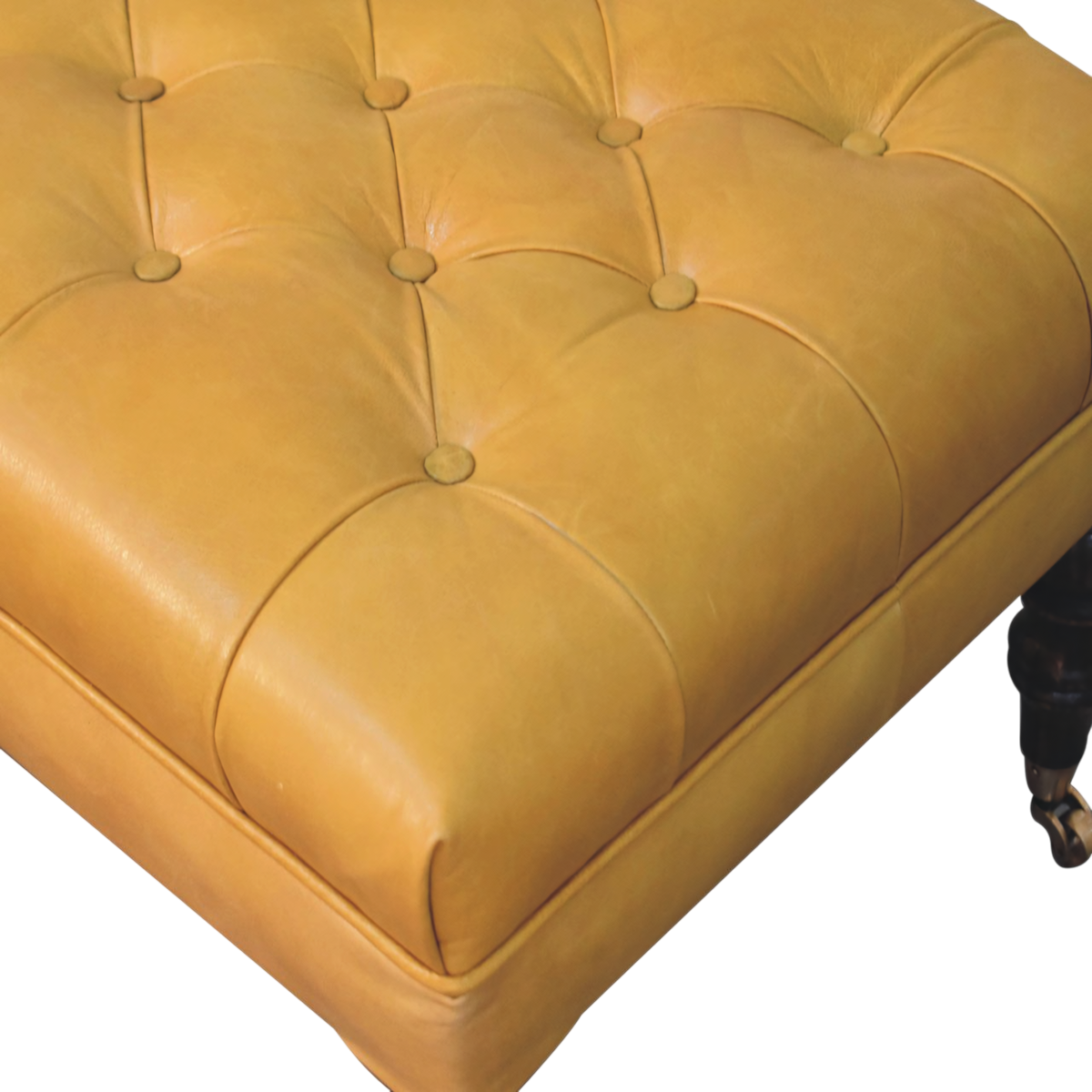 Close view of the hand-set buttoning on the Sussex Leather Ottoman in Blonde Saddle.