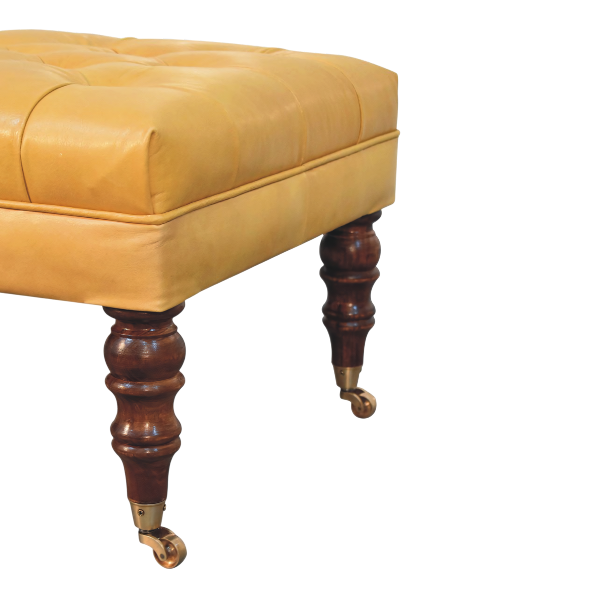 Close view of the brass castors on the Sussex Leather Ottoman in Blonde Saddle.