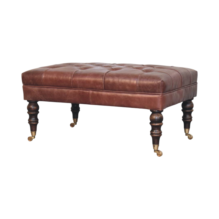 Sussex Leather Ottoman in Cognac, three-quarter view showing the full profile.