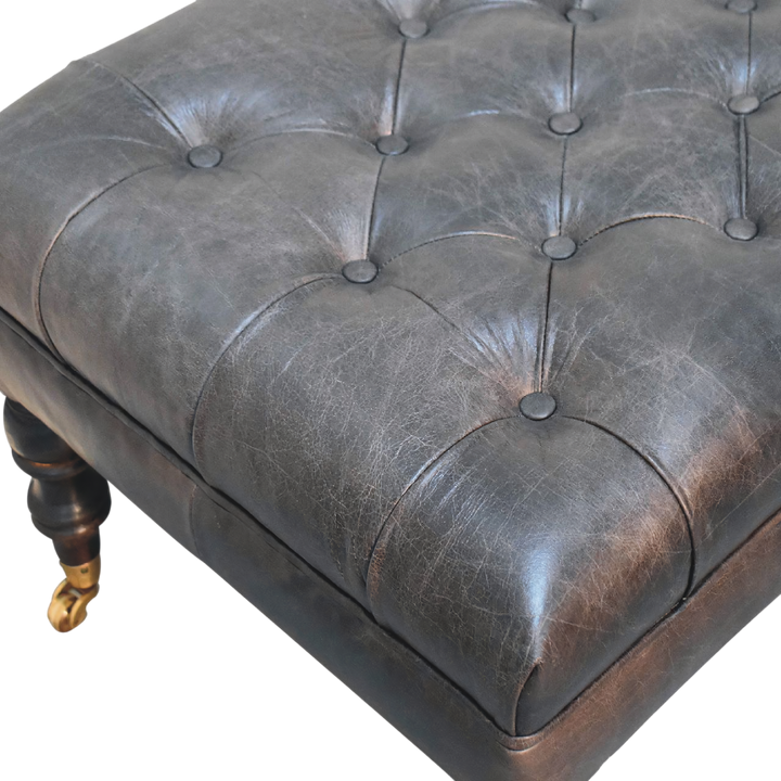 Close view of the hand-set buttoning on the Sussex Leather Ottoman in Espresso.