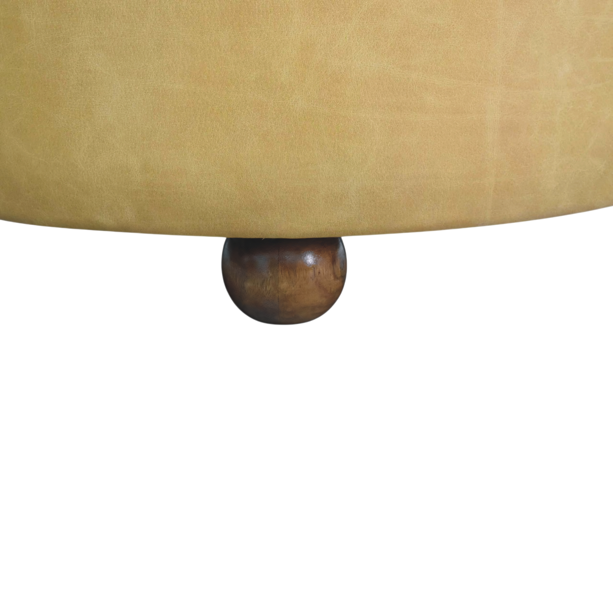 Close view of the feet on the Sussex Round Leather Coffee Table in Blonde Saddle.