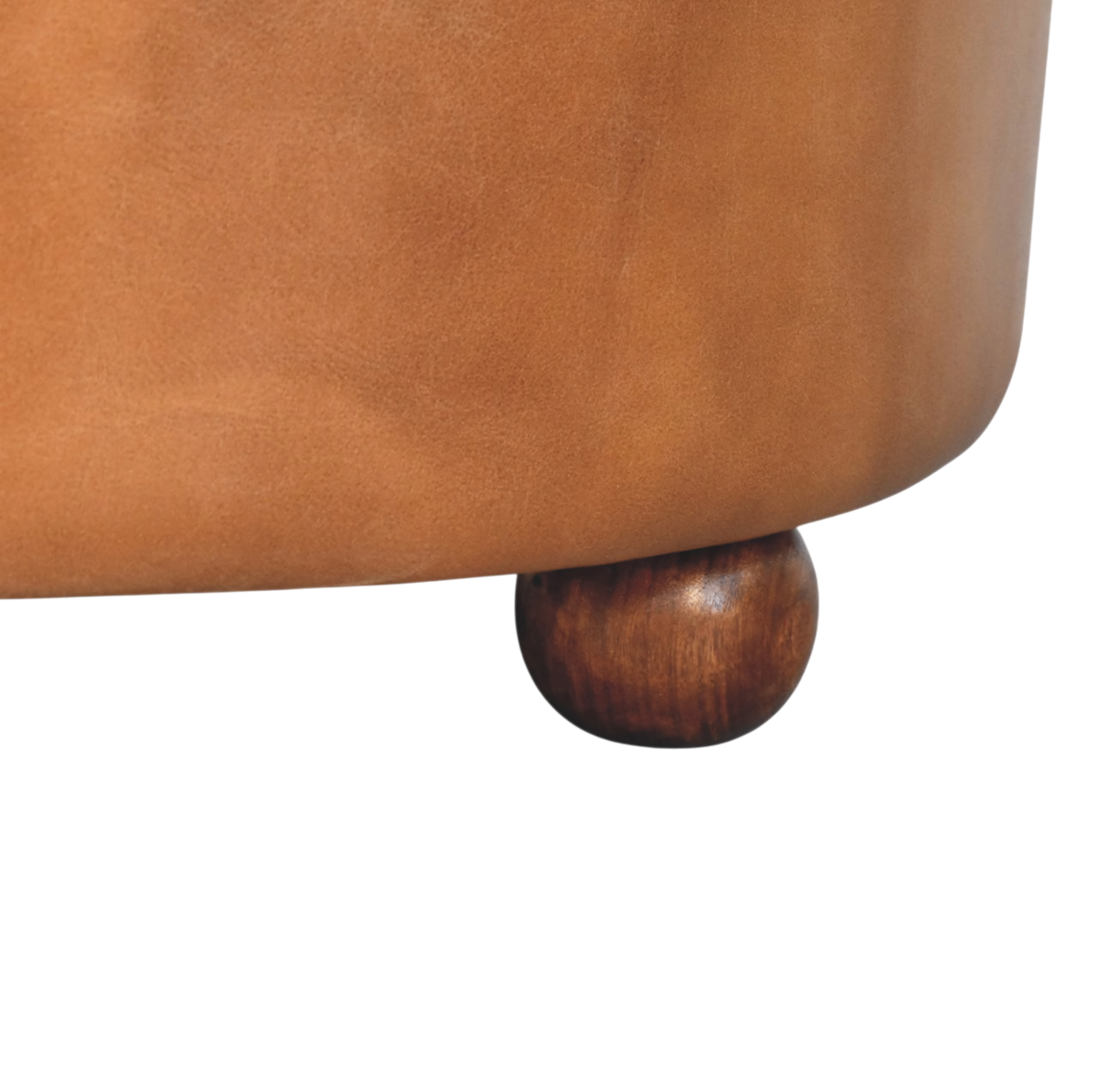 Close view of the feet on the Sussex Round Leather Ottoman in Burnt Caramel.