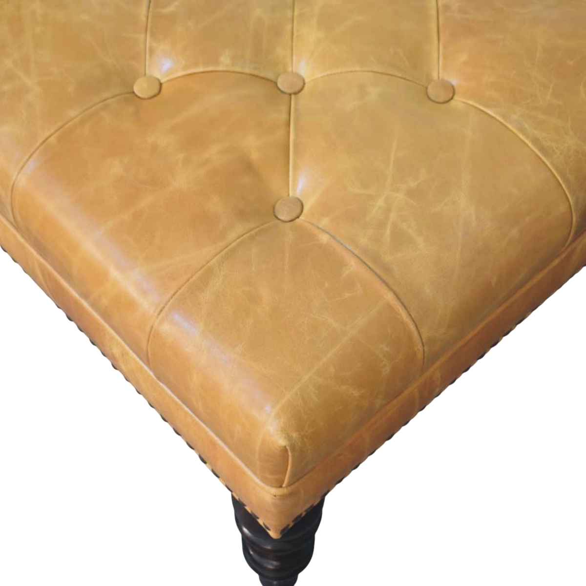 Close view of the stud detailing and button tufting on the Sussex Square Leather Ottoman with Nailheads in Blonde Saddle.
