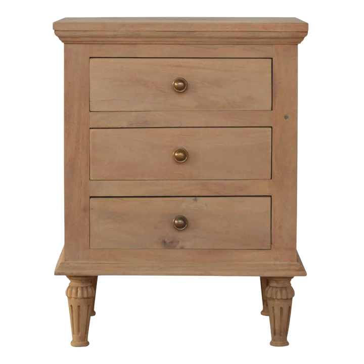 Trosa Bedside Table in Almond, front view. Sun-bleached hardwood, three drawers with brass ring pulls.