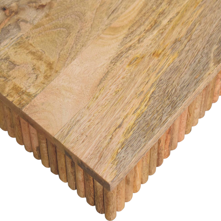 Close view of the carved detailing on the Trosa Block Coffee Table in Amber.