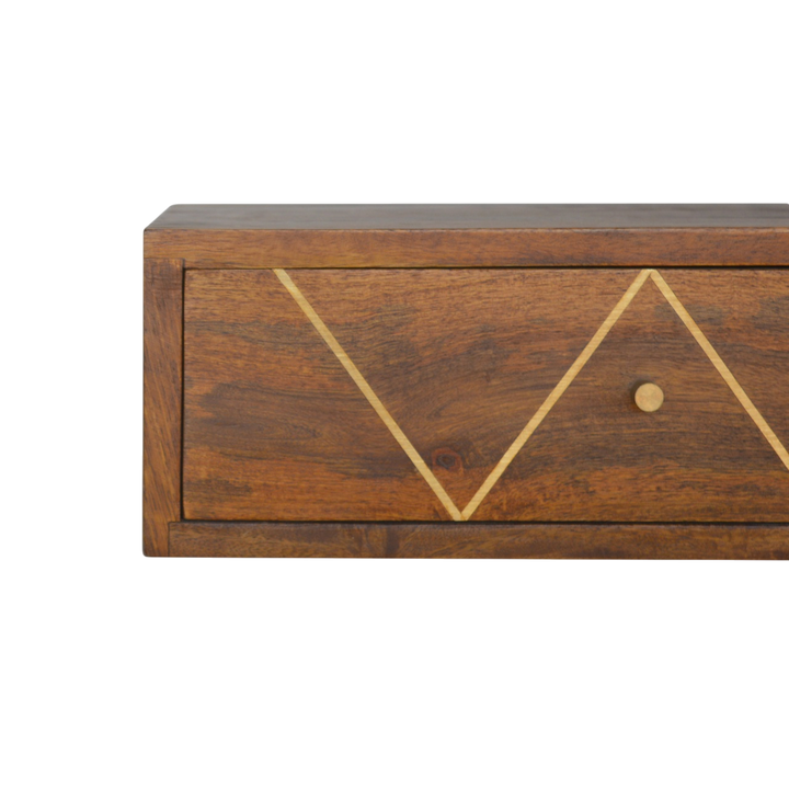 Close view of the drawer front on the Trosa Floating Bedside Shelf in Chestnut.
