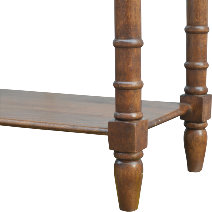 Close view of the stretcher and turned legs on the Wetherby Tiered Hallway Console in Chestnut.
